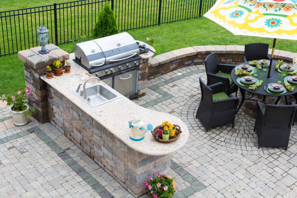 Backyard with outdoor kitchen and dining set