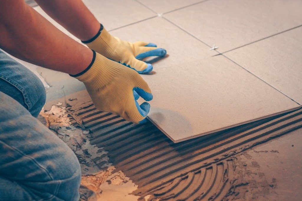 Man installing tiles