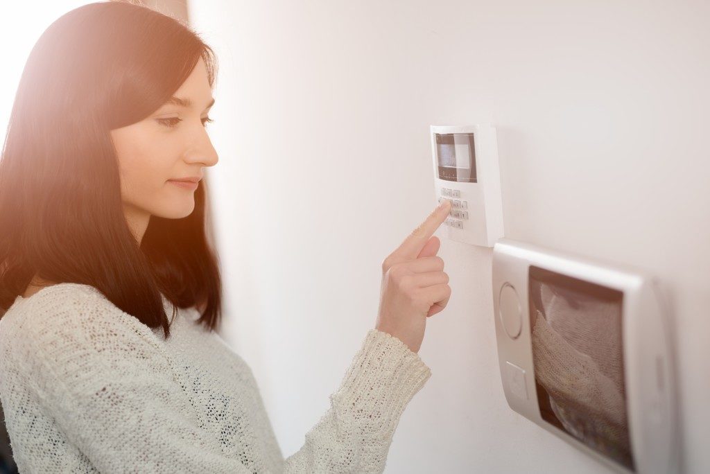 Woman using an alarm system