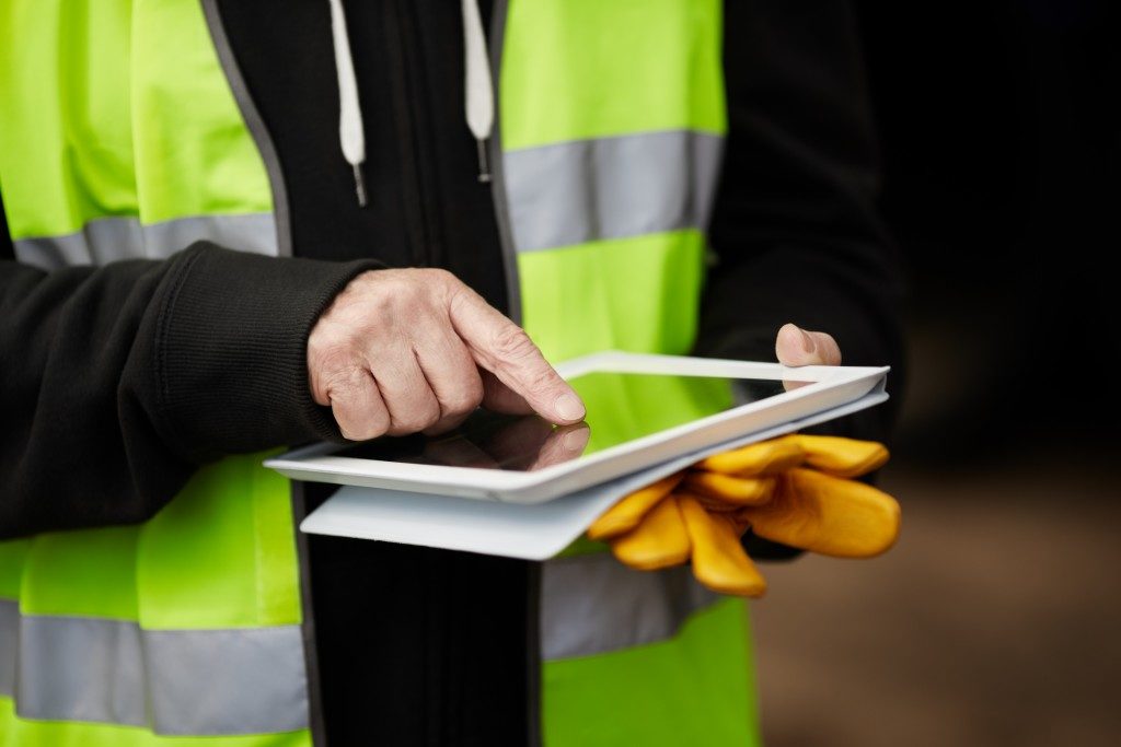 Construction worker using a tablet on site