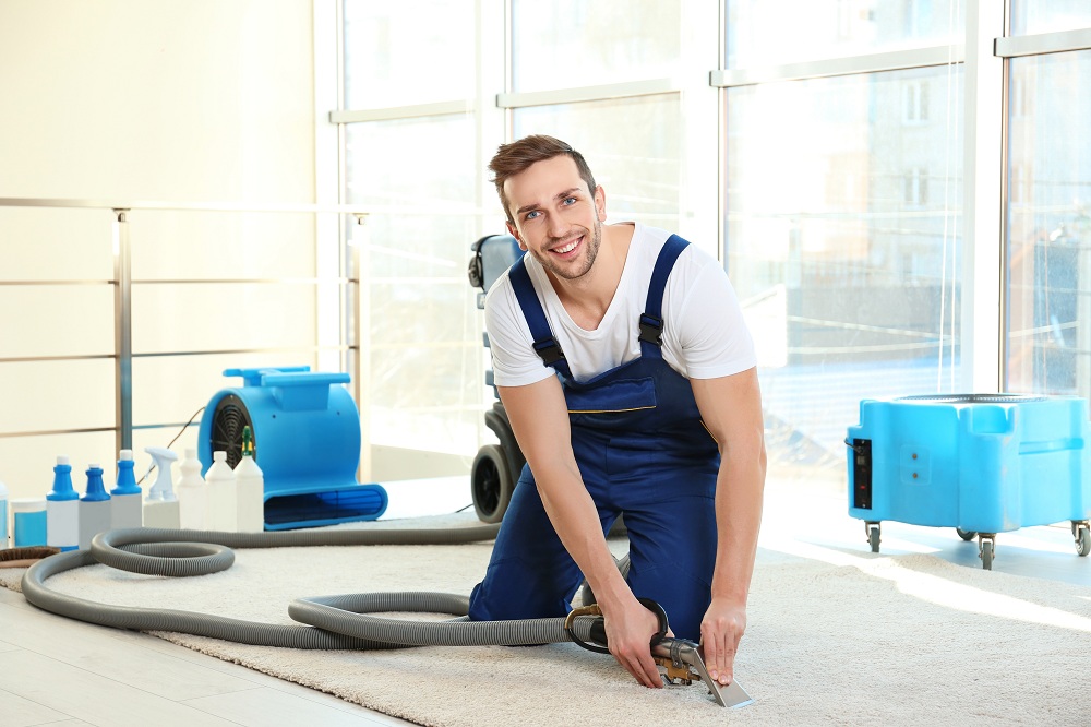a man cleaning a carpet