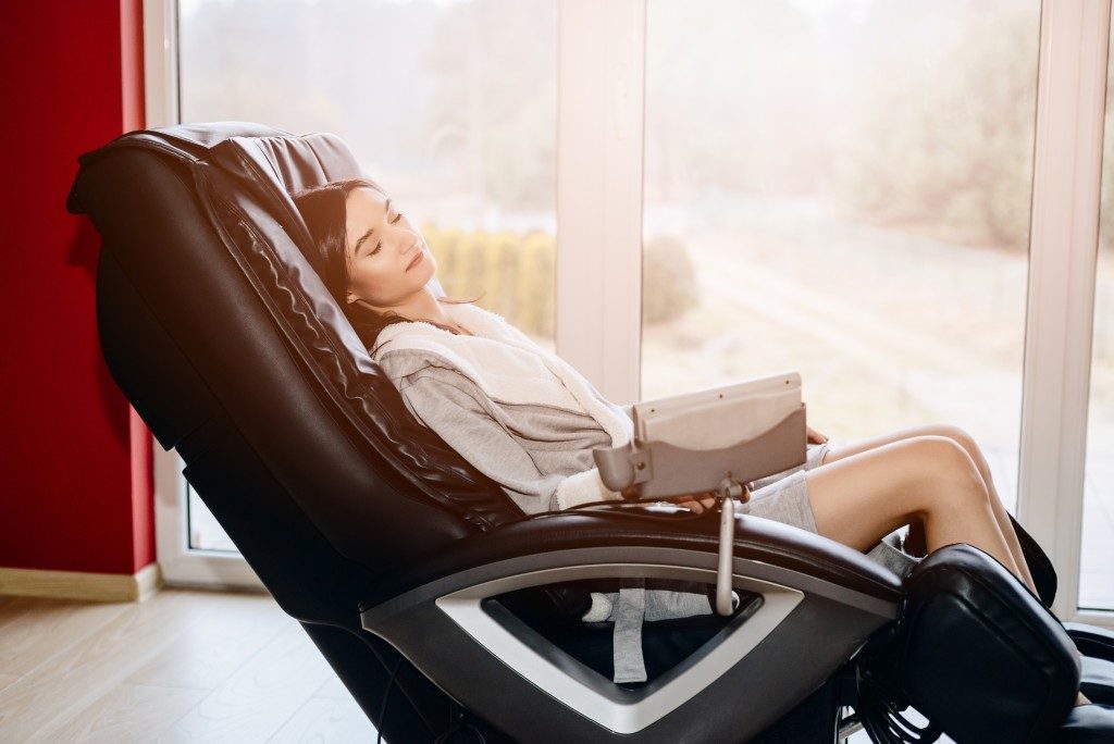 Woman sitting on the massage chair