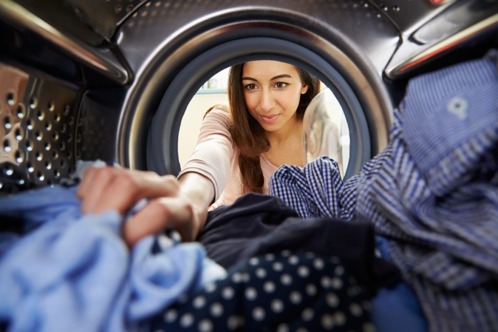 Woman using washing machine