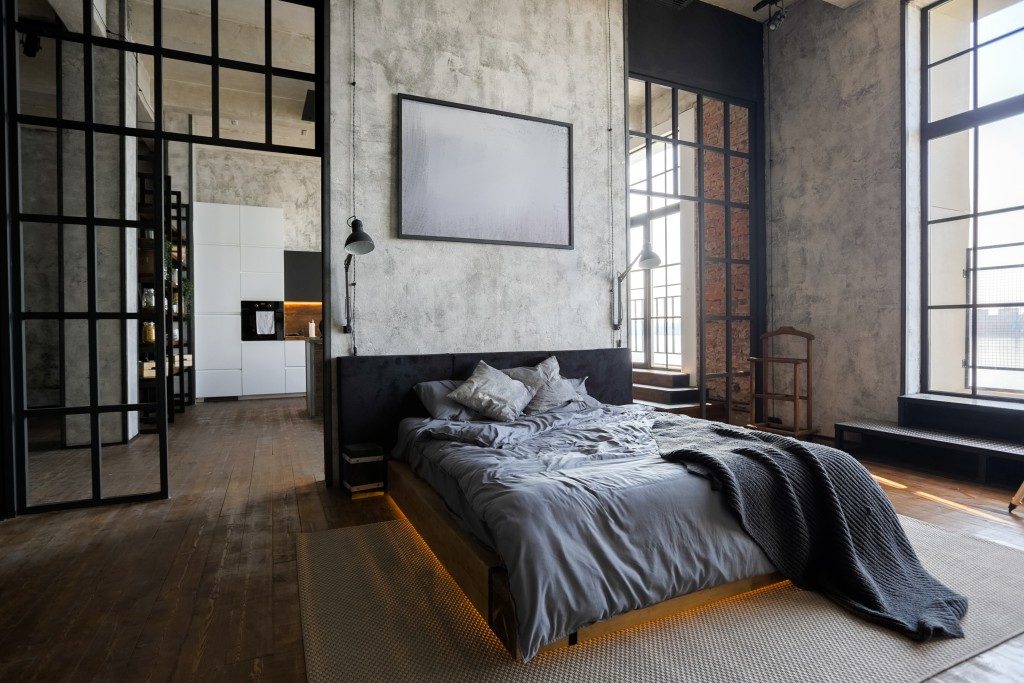 gray bed in a studio type apartment