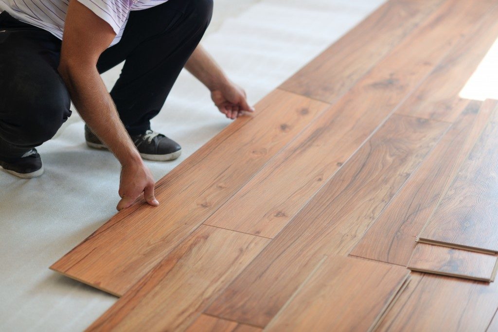 man installing wood flooring