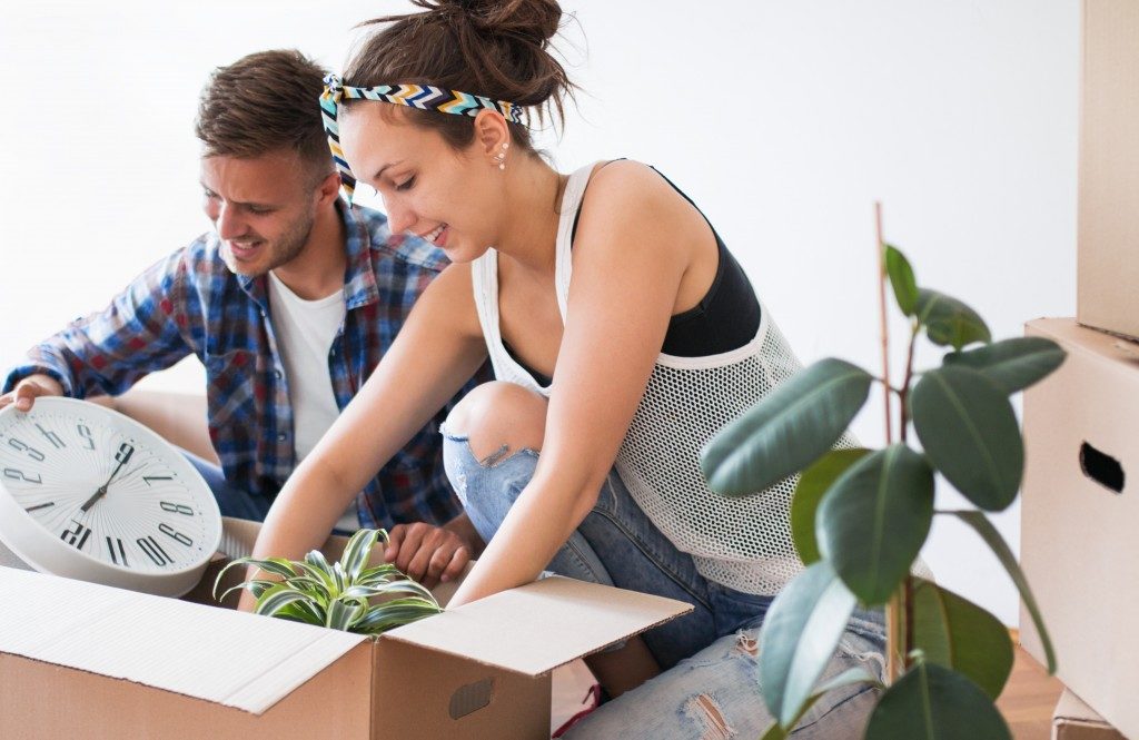 couple unpacking items in new home