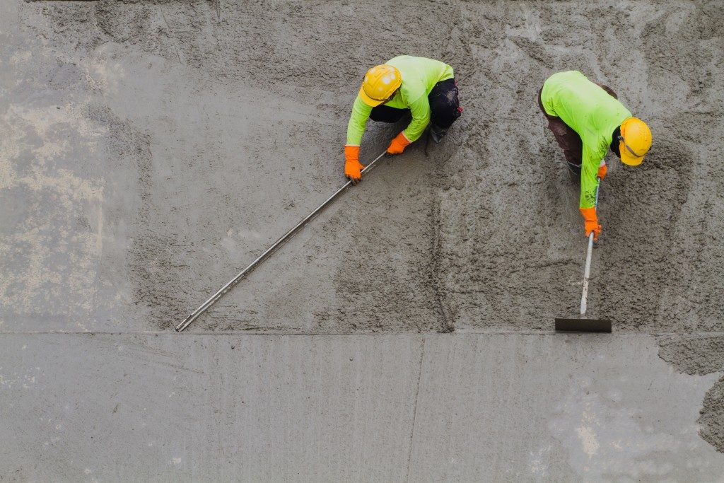Workers laying down concrete