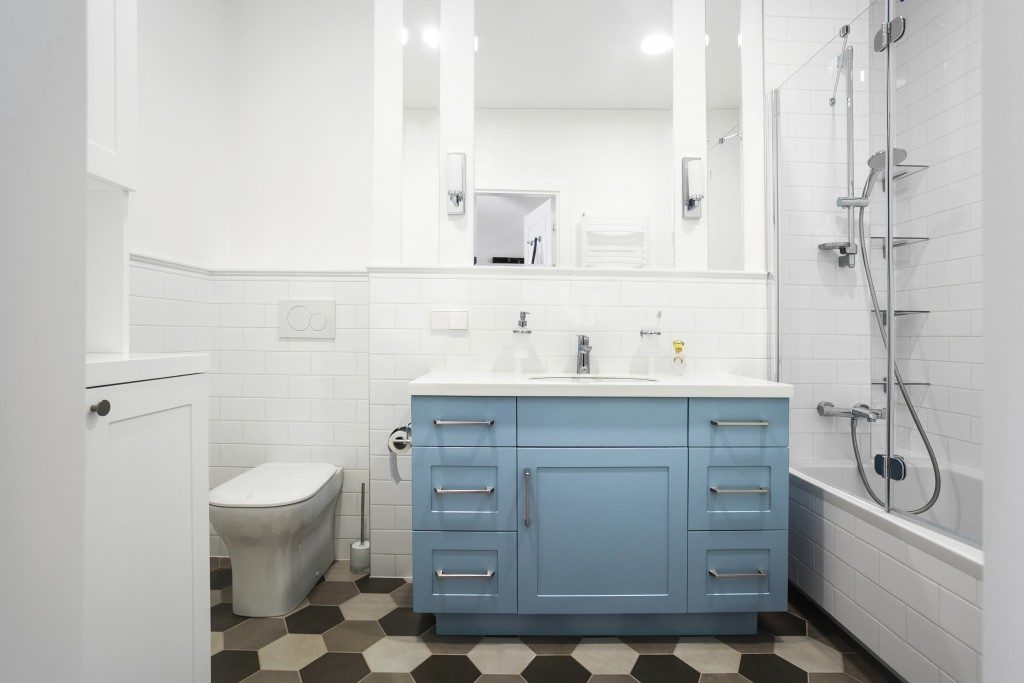 Small bathroom with blue cabinet