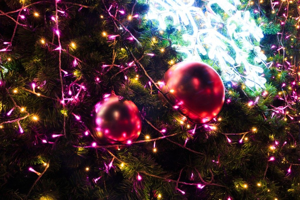 pink christmas lights and balls on a tree