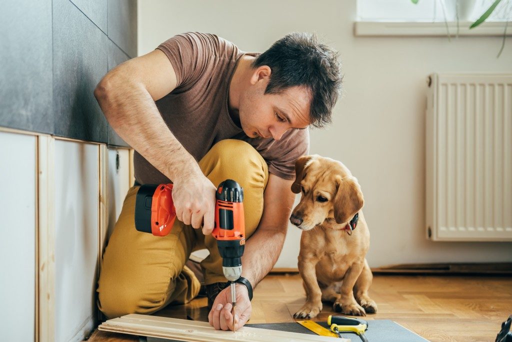 man doing construction work with his dog