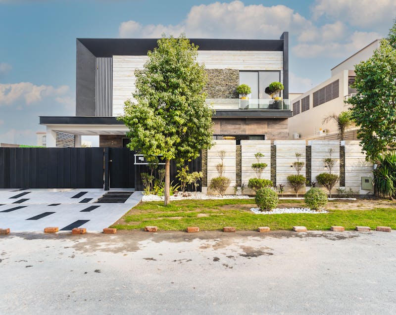 a modern house with a beautiful fence