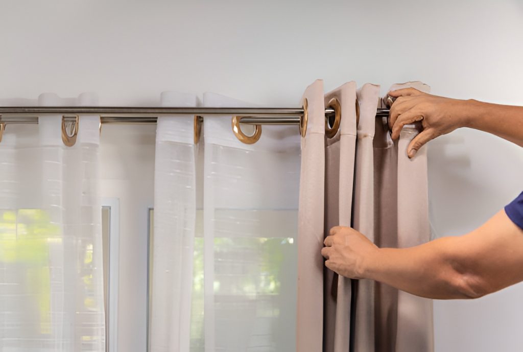 man layering curtains