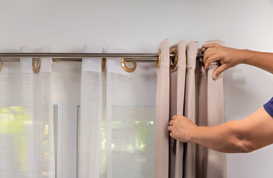 man layering curtains